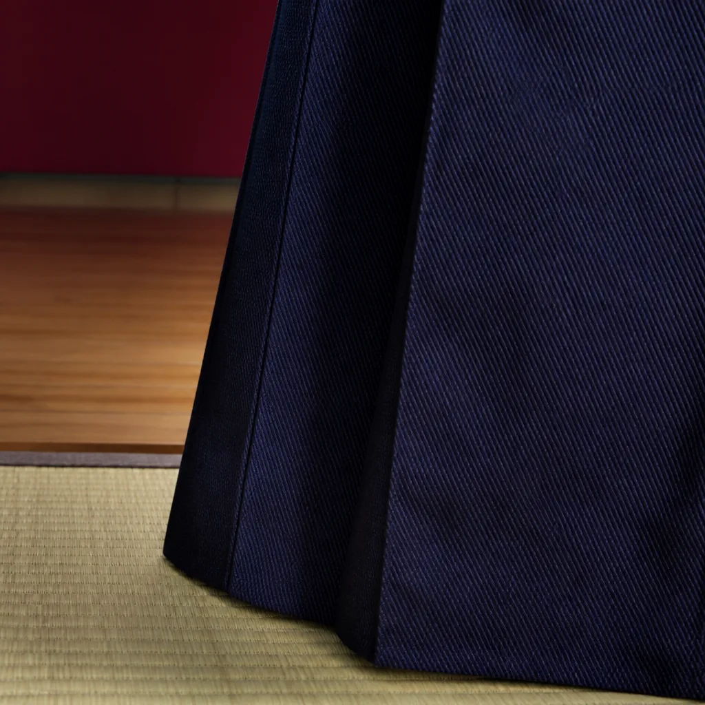 close-up of woven hakama fabric texture showing a fine diagonal weave